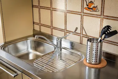 a stainless steel sink with a strainer next to it at Dome Terrace Apartment in Rome