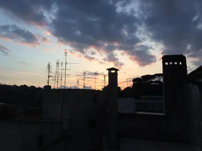 a view of the sunset from the roof of a building at Dome Terrace Apartment in Rome