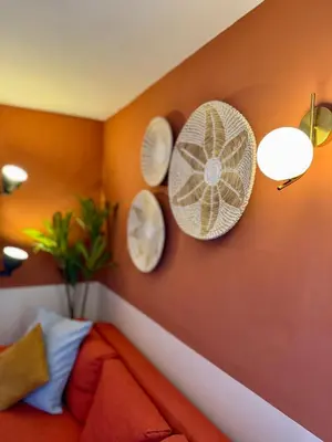 a living room with a couch and plates on the wall at Dome Terrace Apartment in Rome