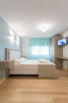a bedroom with a bed and a tv on a wall at Luciano Laterani Guest House in Rome