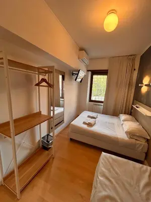 a bedroom with a bed and a book shelf at Luciano Laterani Guest House in Rome