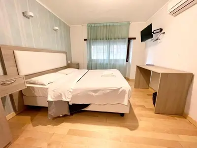 a bedroom with a bed and a desk in it at Luciano Laterani Guest House in Rome