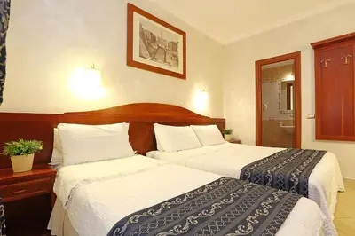 a hotel room with two beds with white sheets at Adorasuite B&B in Rome