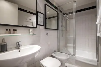 a bathroom with a sink and a toilet and a shower at HT N°9 Colosseo in Rome