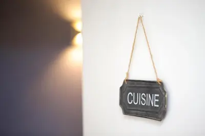 a sign that says cuisine hanging on a wall at HT N°9 Colosseo in Rome