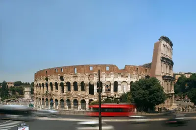 a bus is driving past the coliseum at HT N°9 Colosseo in Rome