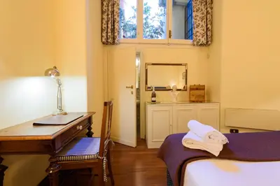 a bedroom with a desk and a bed and a desk and a mirror at Apartment Margutta Center in Rome