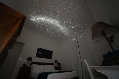 a bedroom with a bed and a ceiling with stars at B&B Domus Quiritum in Rome