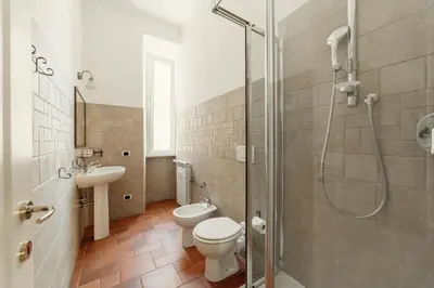 a bathroom with a shower and a toilet and a sink at B&B Domus Quiritum in Rome