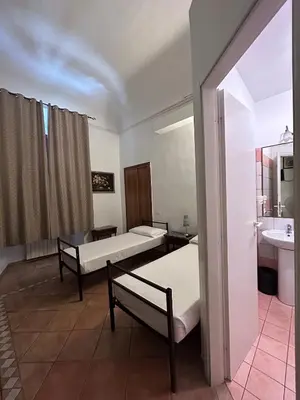 a hospital room with two beds and a sink at Hotel Il Papavero in Rome