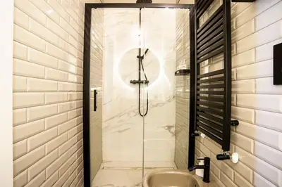 a glass shower with a sink in a bathroom at Buonanotte Colosseo in Rome