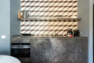 a kitchen with a stainless steel counter with a stove at Buonanotte Colosseo in Rome
