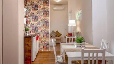 a kitchen and a dining room with a table and chairs at Sweet Rooms Piramide Bed and Breakfast in Rome