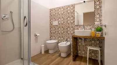 a bathroom with a toilet and a sink and a shower at Sweet Rooms Piramide Bed and Breakfast in Rome