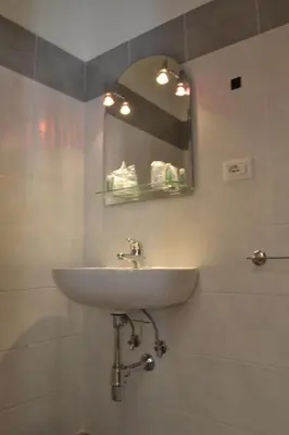 a bathroom with a sink and a mirror at Villa Riari Garden in Rome
