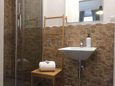 a bathroom with a sink and a shower at SmooRoomS Roma Ostiense in Rome