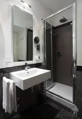a bathroom with a sink and a shower with a mirror at Residence Regola in Rome