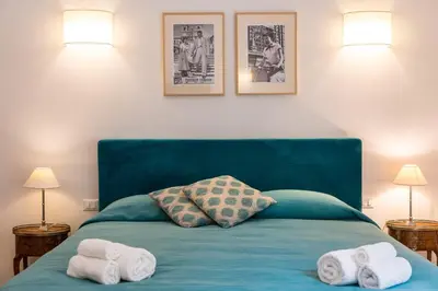 a bedroom with a blue bed with towels on it at Prestigious Apartment via Barberini in Rome