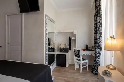 a bedroom with a mirror and a desk and a bed at I Fiumi Di Navona in Rome