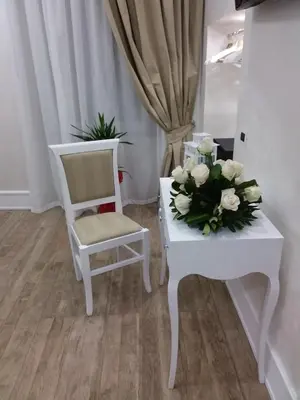 a room with two chairs and a table with flowers on it at I Fiumi Di Navona in Rome