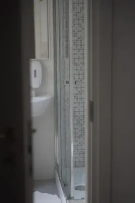 a bathroom with a glass shower and a sink at Casa Mia Guesthouse in Rome