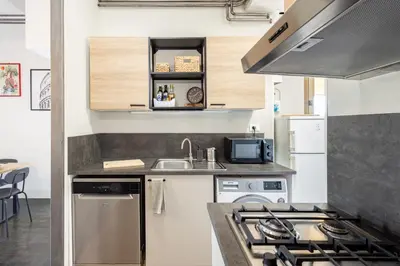 a small kitchen with a sink and a stove at Colosseo Apartment Holiday - Attico al Colosseo a Monti in Rome