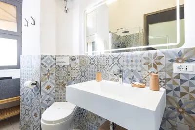 a bathroom with a sink and a toilet at Colosseo Apartment Holiday - Attico al Colosseo a Monti in Rome