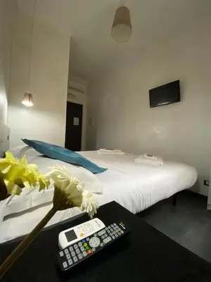 a room with a bed and a remote control on a table at The Place In Rome Guest House in Rome