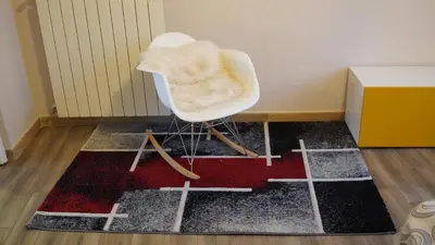 a white chair sitting on a rug in a room at Residenza a San Pietro in Rome