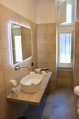 a bathroom with a sink and a mirror at Residenza a San Pietro in Rome
