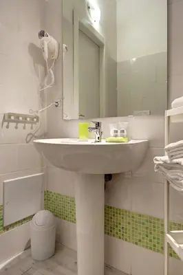 a bathroom with a sink and a mirror at Pianeta Roma 62 in Rome