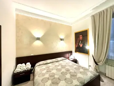 a bedroom with a bed and a picture on the wall at Chroma Italy - Chroma Tessera in Rome
