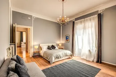 a bedroom with a bed and a large window at The Great Retrò in Rome