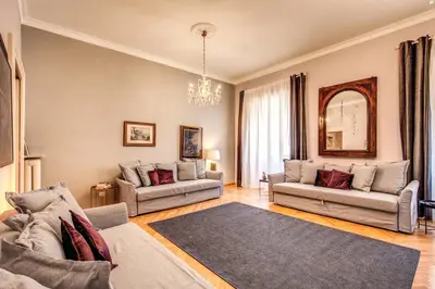 a living room with two couches and a rug at The Great Retrò in Rome