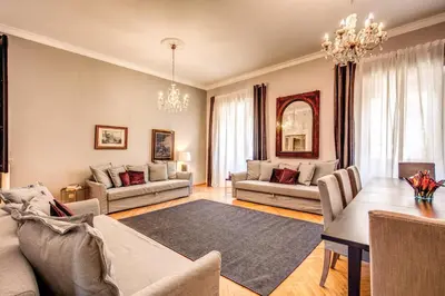 a living room with two couches and a table at The Great Retrò in Rome