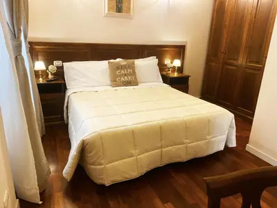 a bedroom with a large bed with two night stands at Relais Cavour in Rome