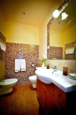 a bathroom with a sink and a toilet and a mirror at Relais Cavour in Rome