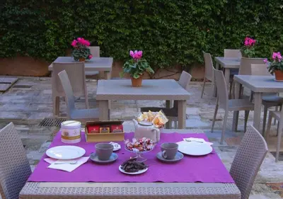 a picnic table with a purple table cloth on it at Relais Villa Coppedè in Rome