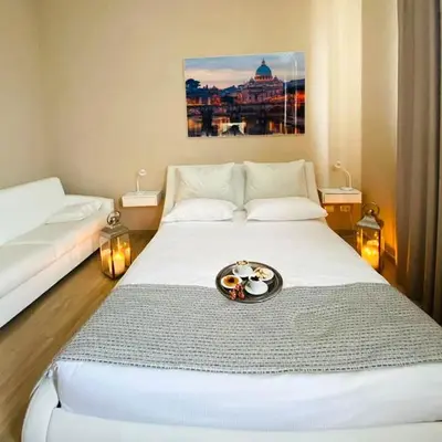 a room with a bed with a plate of food on it at Relais Villa Coppedè in Rome