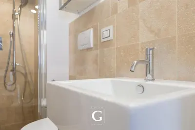 a bathroom with a white sink and a shower at Residenza Gonfalone in Rome