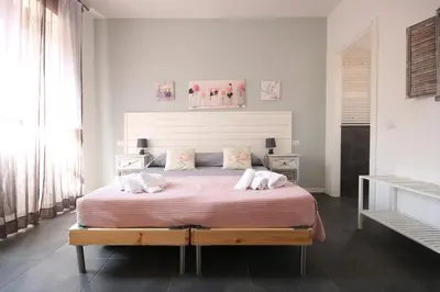 a bedroom with a large bed with two pillows at Le Cupole in Rome