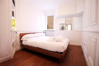 a bedroom with a bed with white sheets and a window at Charm & Design in Gourmet District in Rome