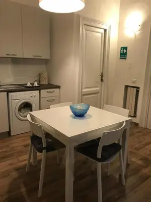 a kitchen with a table and chairs with a bowl on it at Roma My Home B&B in Rome