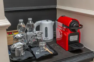 a counter with a toaster and other items in a refrigerator at Rome Central Inn in Rome
