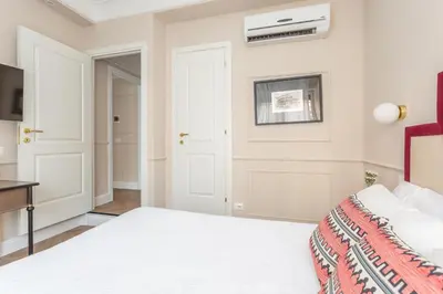 a bedroom with a bed and a air conditioner on the wall at Rome Central Inn in Rome