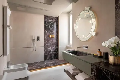 a bathroom with a sink and a mirror at The Pantheon Iconic Rome Hotel, Autograph Collection in Rome