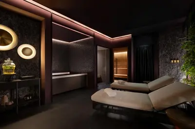 a living room with two beds and a couch at The Pantheon Iconic Rome Hotel, Autograph Collection in Rome