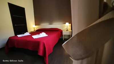 a hotel room with a red bed with towels on it at Rome Vatican Suite in Rome