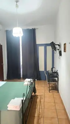a hospital room with two beds and a spotlight at Meltin' Rome Guest House in Rome