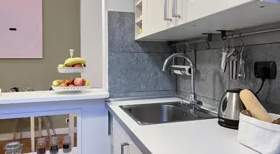 a kitchen with a sink and a bowl of fruit at NTB Roma B&B in Rome
